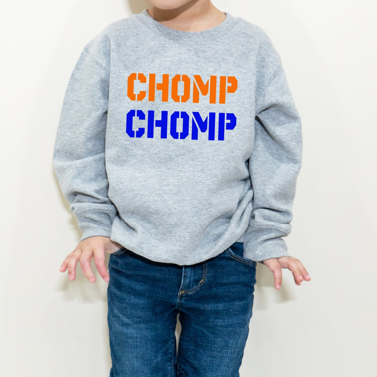 boy wearing chomp chomp orange and blue sweatshirt
