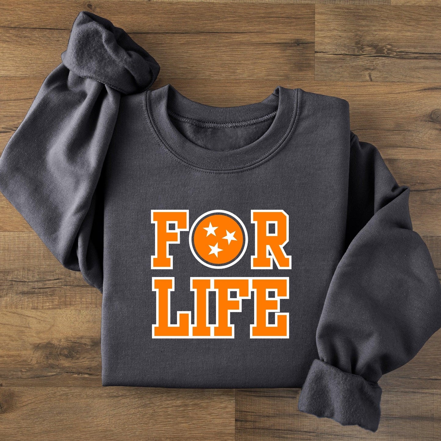 Dark gray sweatshirt with 'FOR LIFE' in orange on a wooden surface