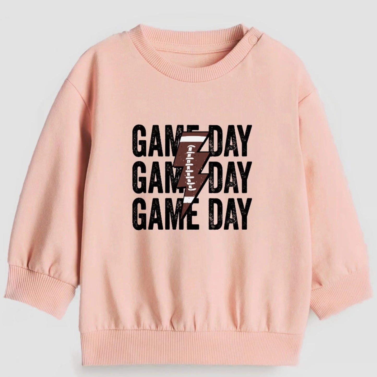 Pink sweatshirt with 'GAMEDAY' text and number 7 on a light gray background