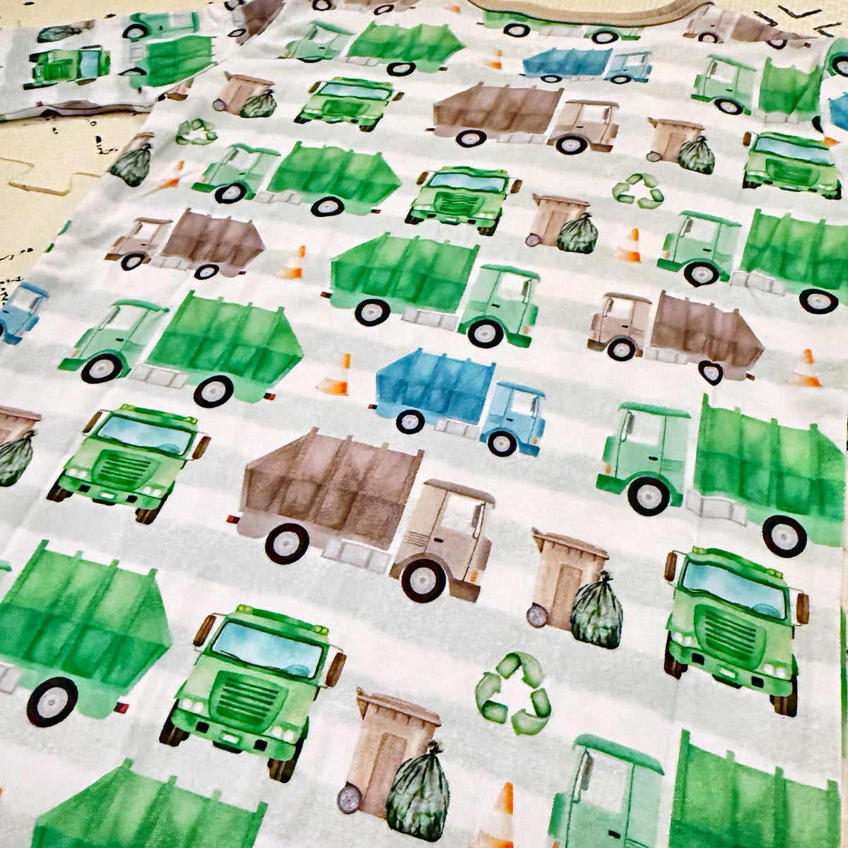 Bamboo pajamas with green garbage trucks and recycling bins pattern on a white background