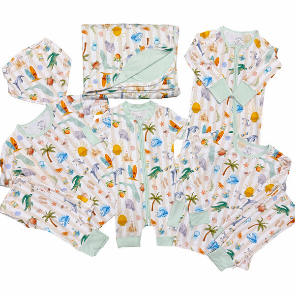 Collection of children's clothing with Florida beach-themed design on a white background
