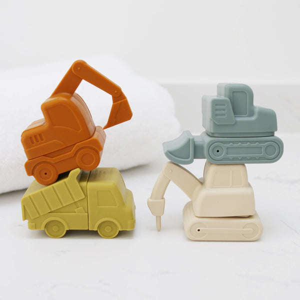 Four bath toy construction vehicles, an orange excavator and a green bulldozer, on a white background.