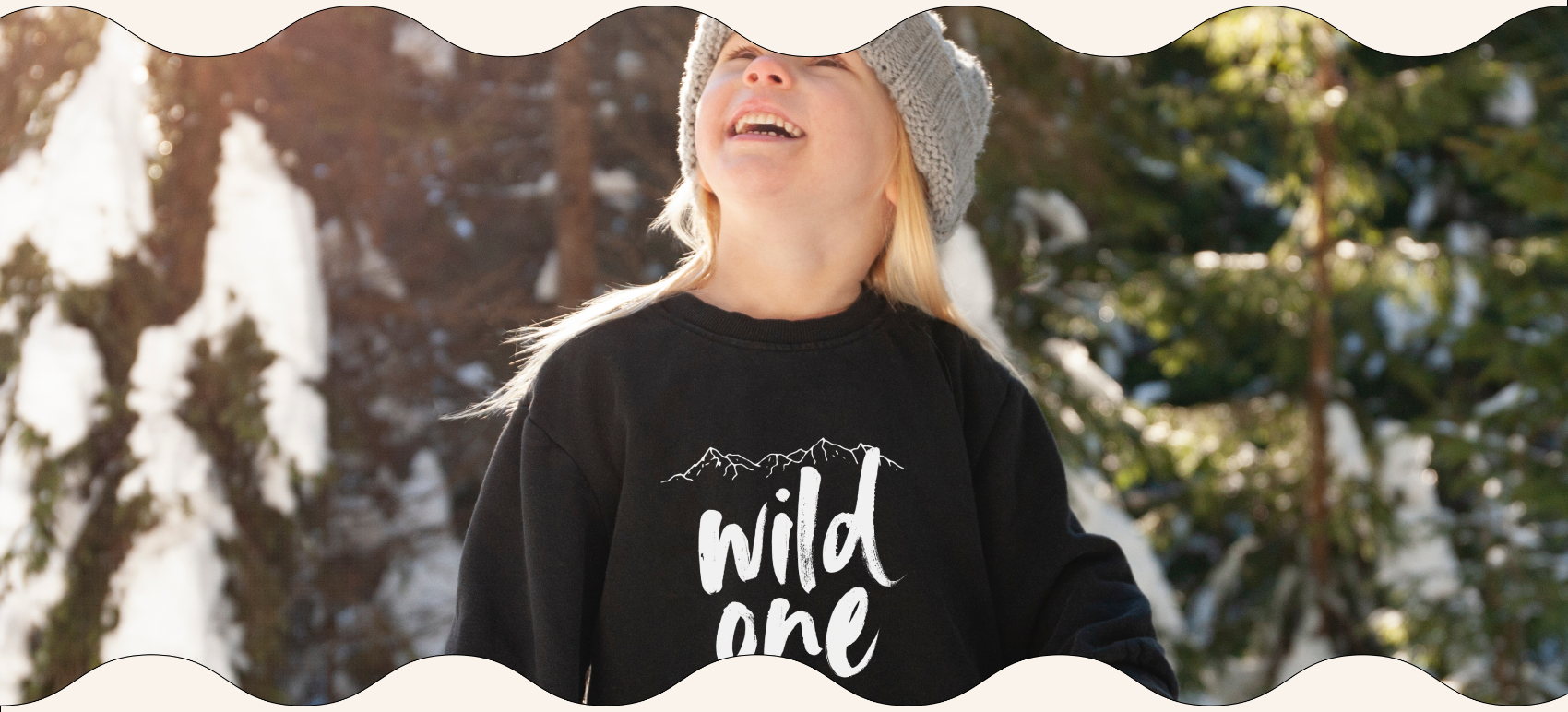 Child wearing wild one sweatshirt in snow
