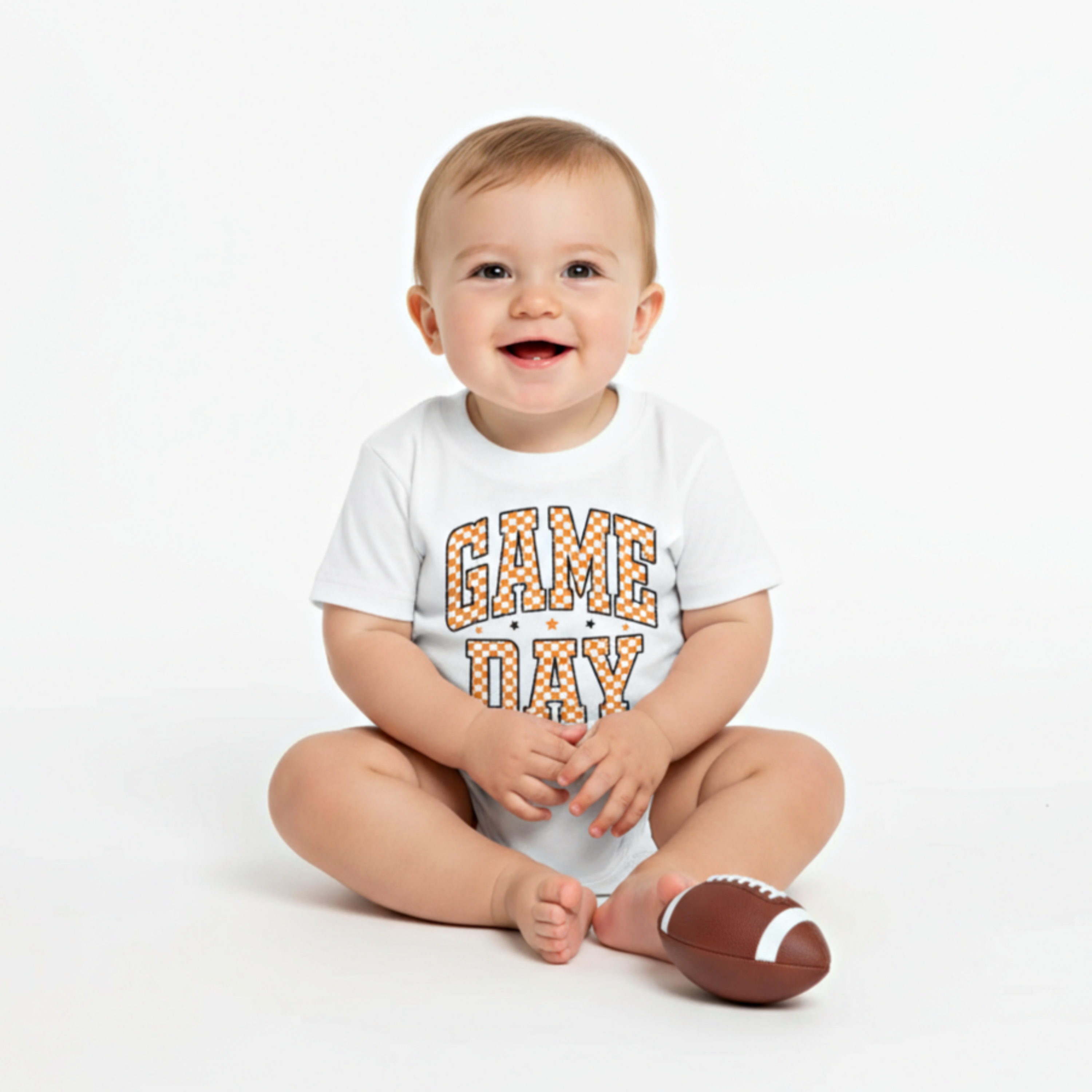 baby boy in orange and white checkered game day print onesie

