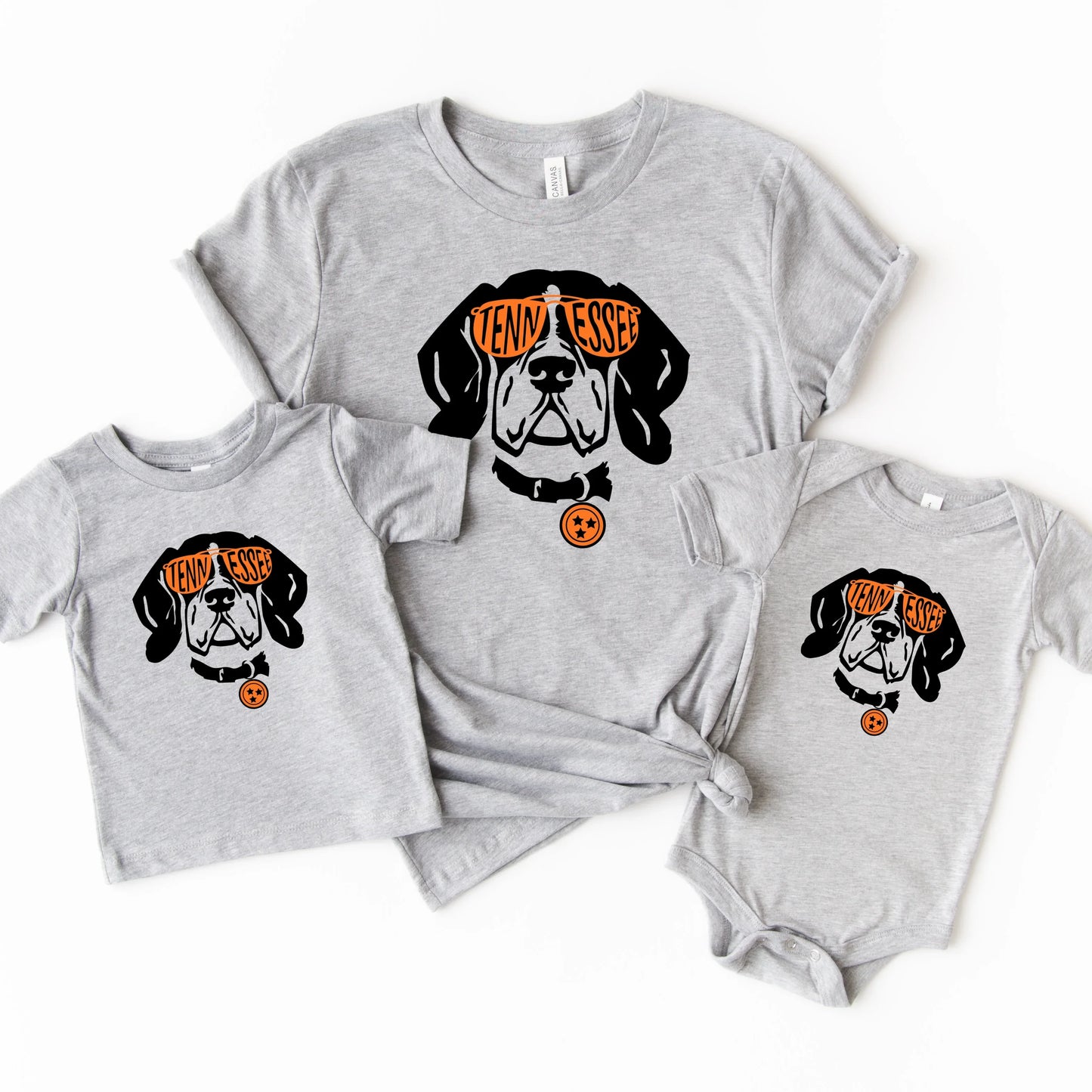 Gray t-shirt with a Tennessee dog graphic and text, paired with a baby onesie on a white background