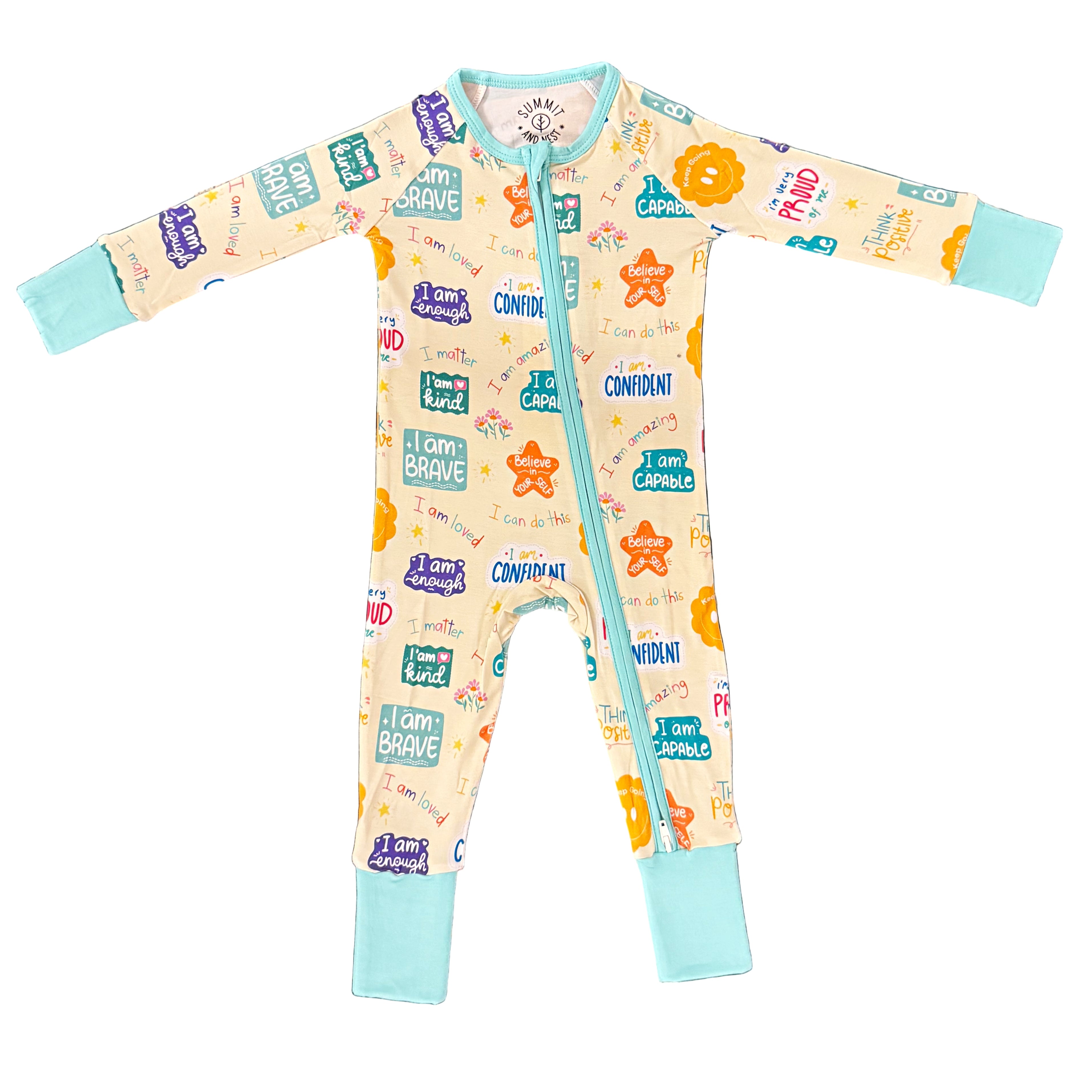 Baby onesie with motivational phrases on a textured blue and white surface