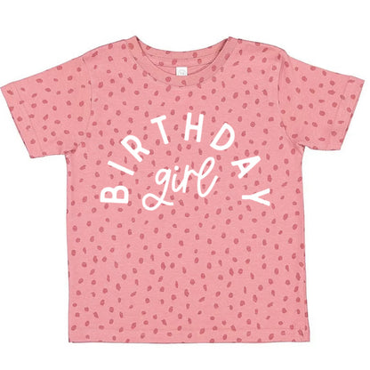 Pink t-shirt with 'Birthday girl' text and small patterns on a white background