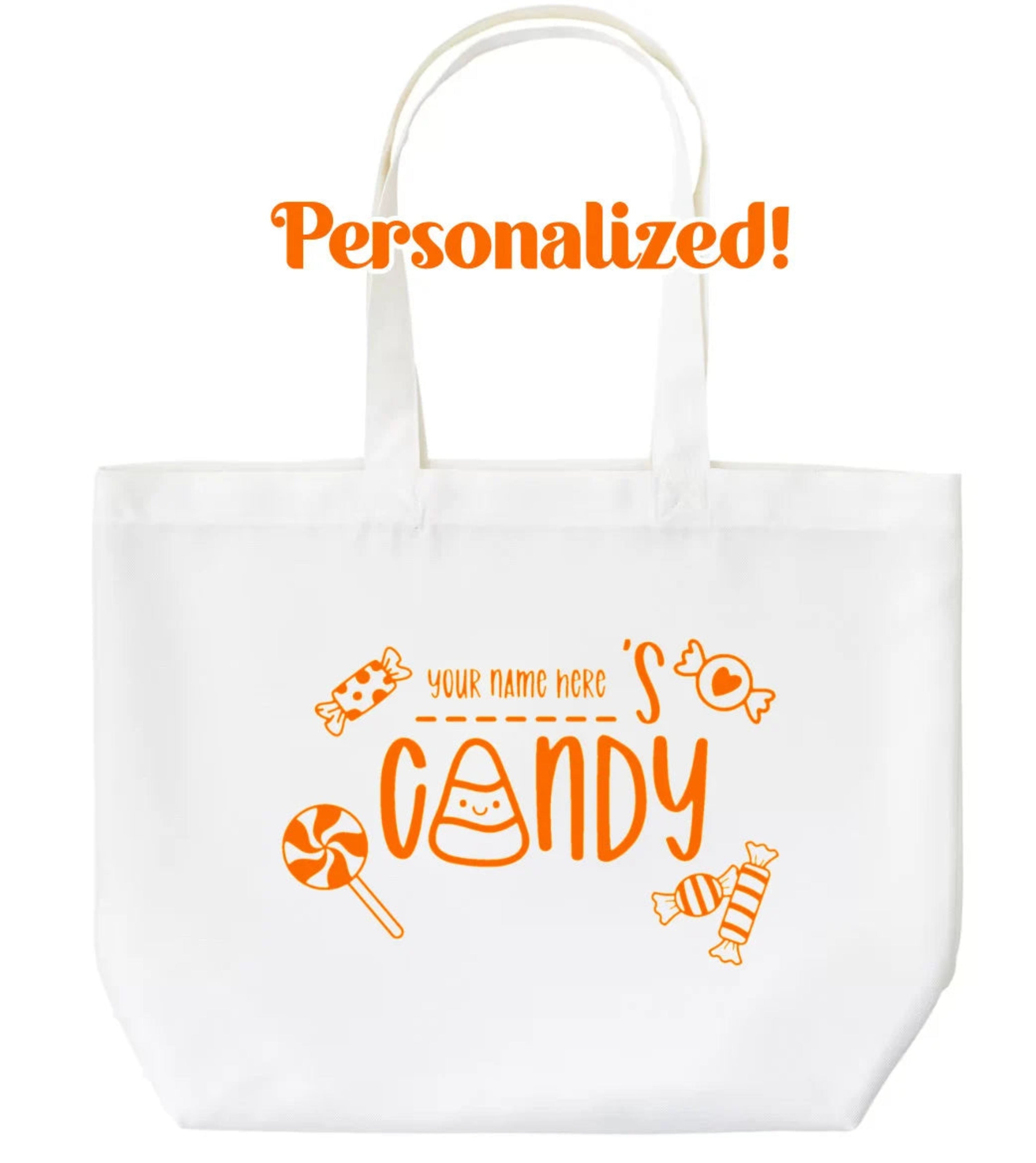 White tote bag with orange candy-themed text and graphics on a white background