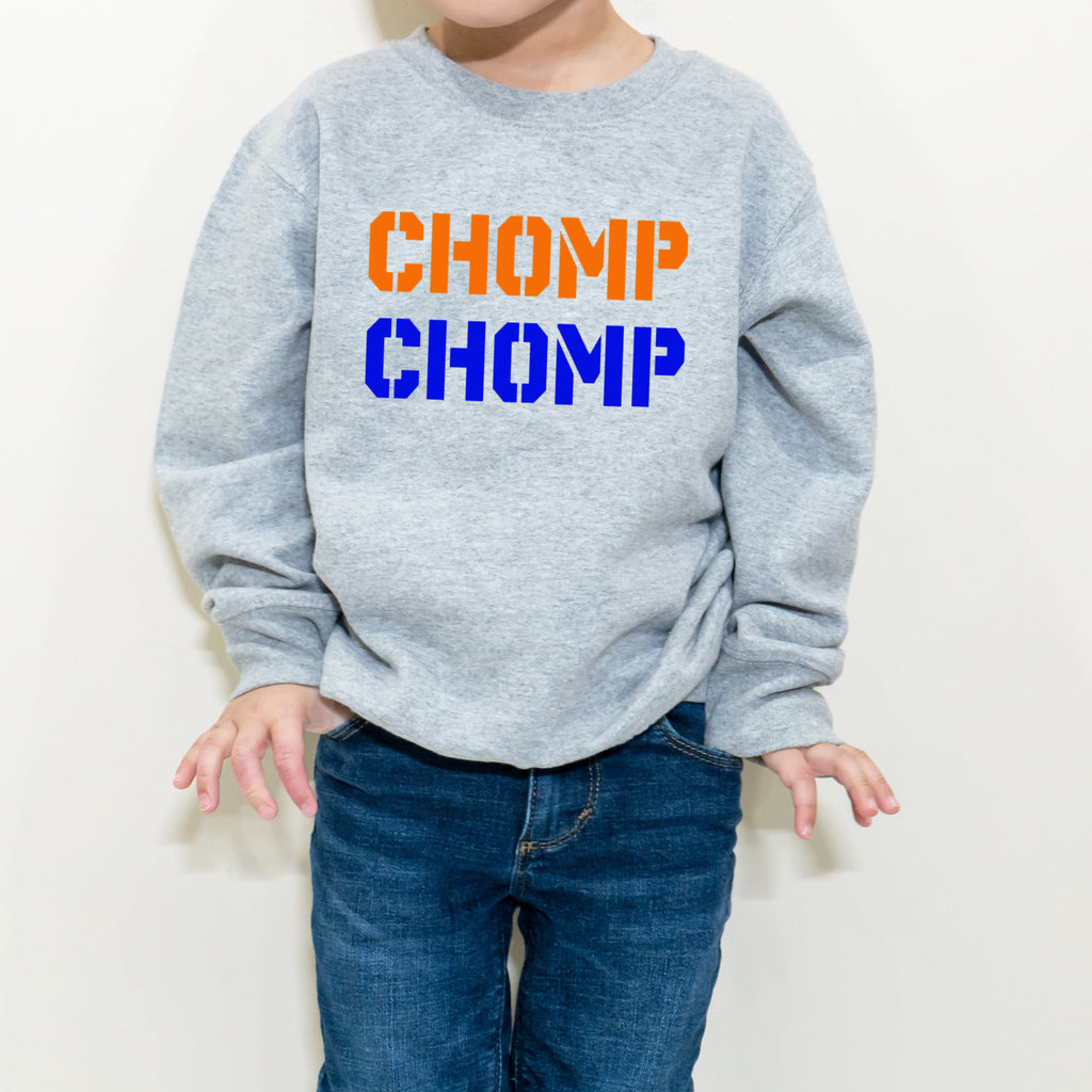 boy wearing chomp chomp orange and blue sweatshirt
