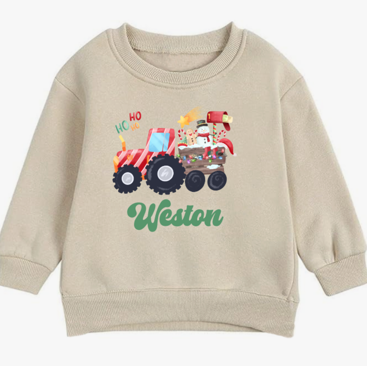 Beige sweatshirt with a Christmas truck design and 'Weston' text on a white background