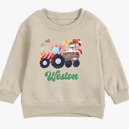 Beige sweatshirt with a Christmas truck design and 'Weston' text on a white background
