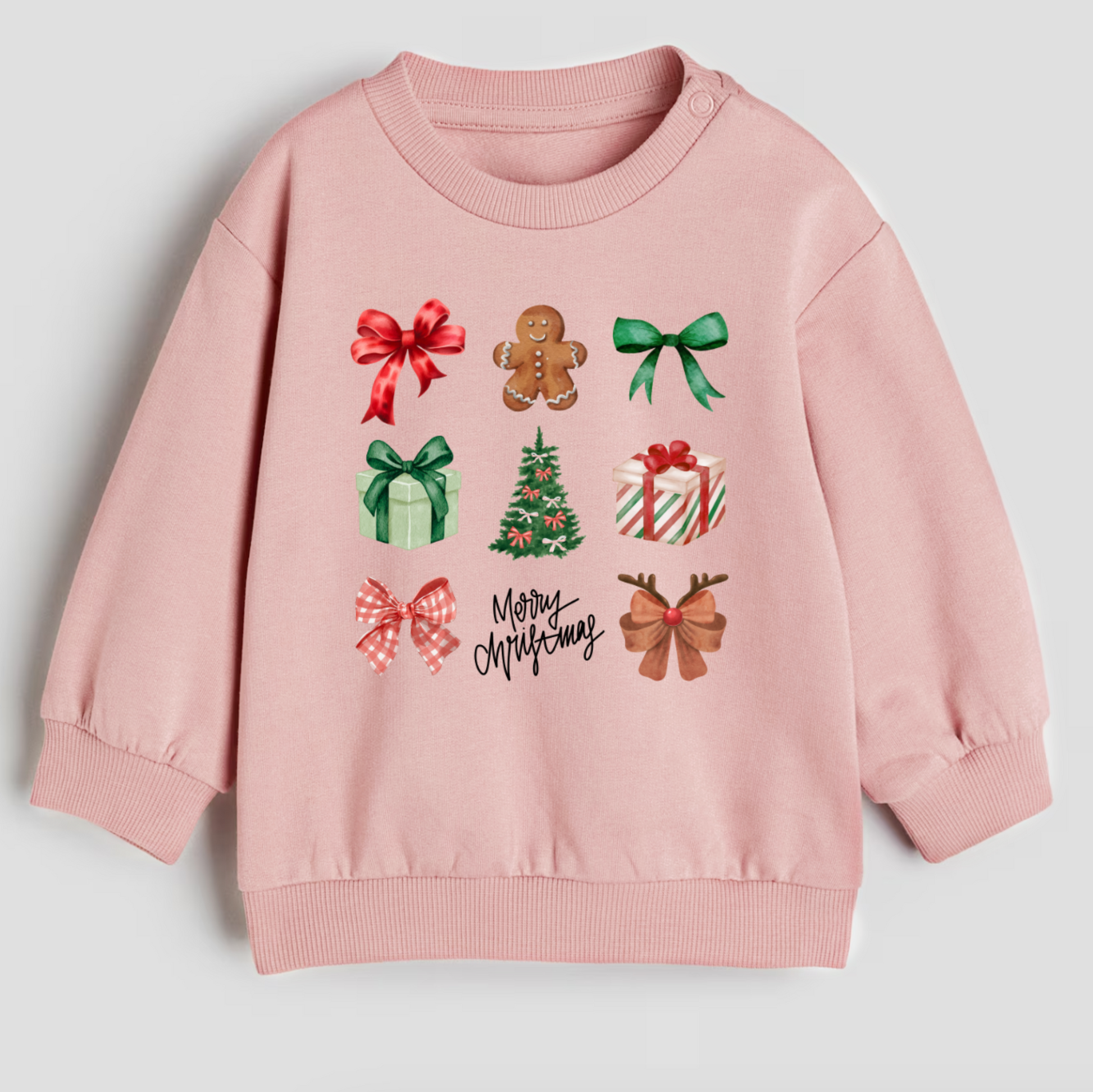 Pink sweatshirt with Christmas-themed graphics on a light gray background