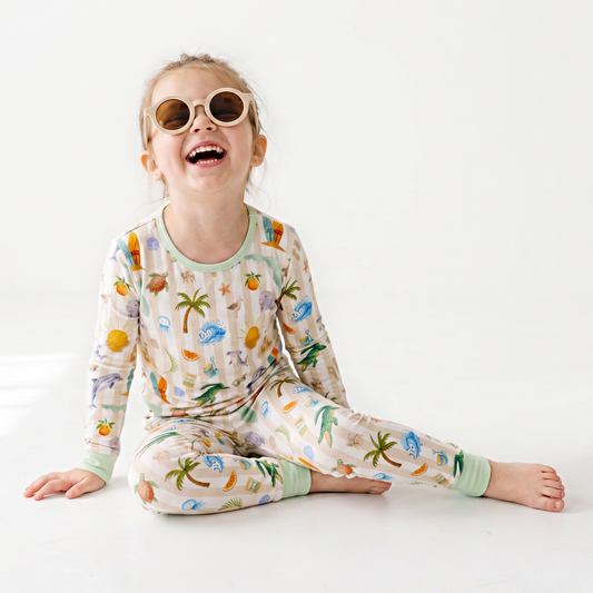 Child wearing a colorful florida
pajama set with a white background