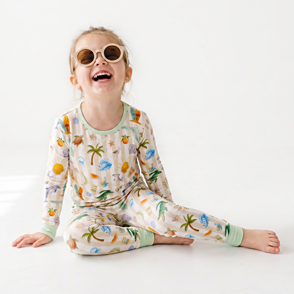 Child wearing a colorful florida
pajama set with a white background