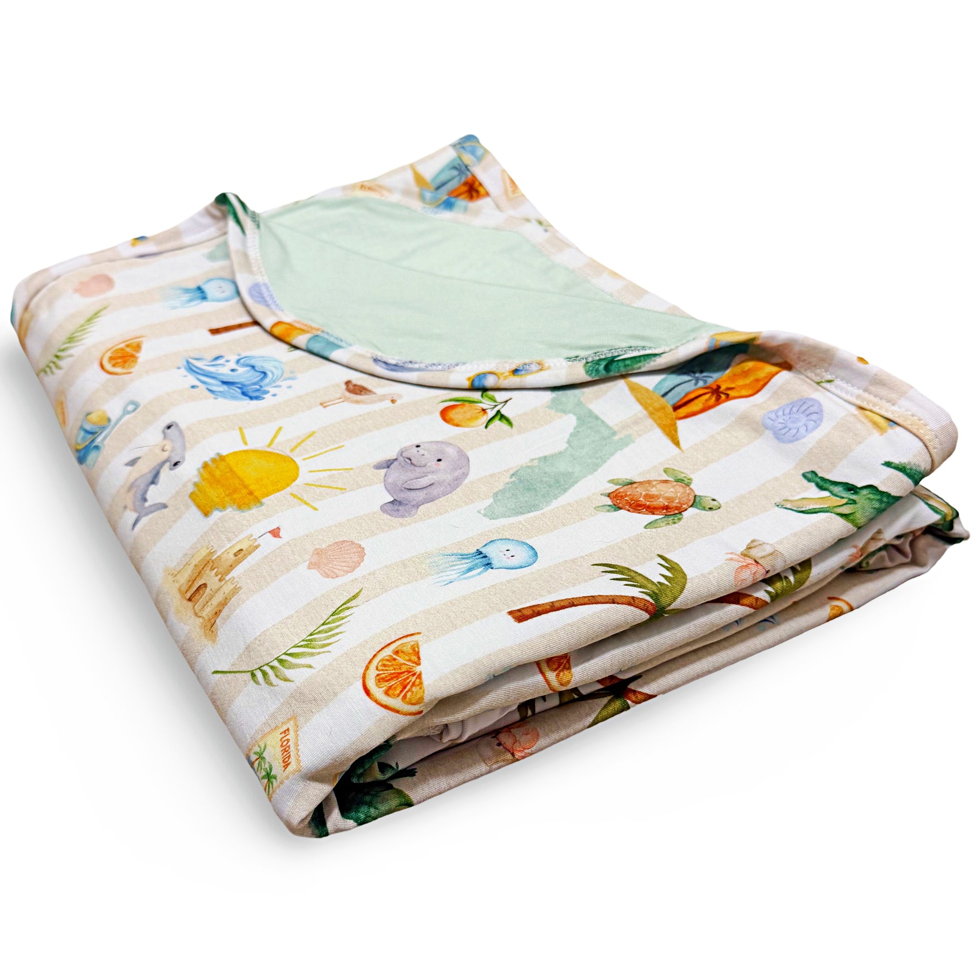Folded baby blanket with colorful Florida beach pattern on a white background