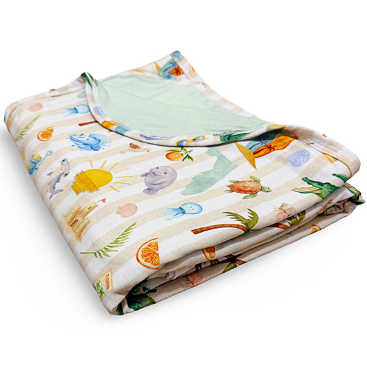 Folded baby blanket with colorful Florida beach pattern on a white background
