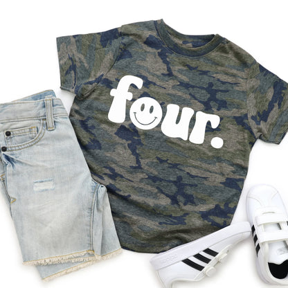 Camouflage t-shirt with 'four' print, denim shorts, and white sneakers on a white background