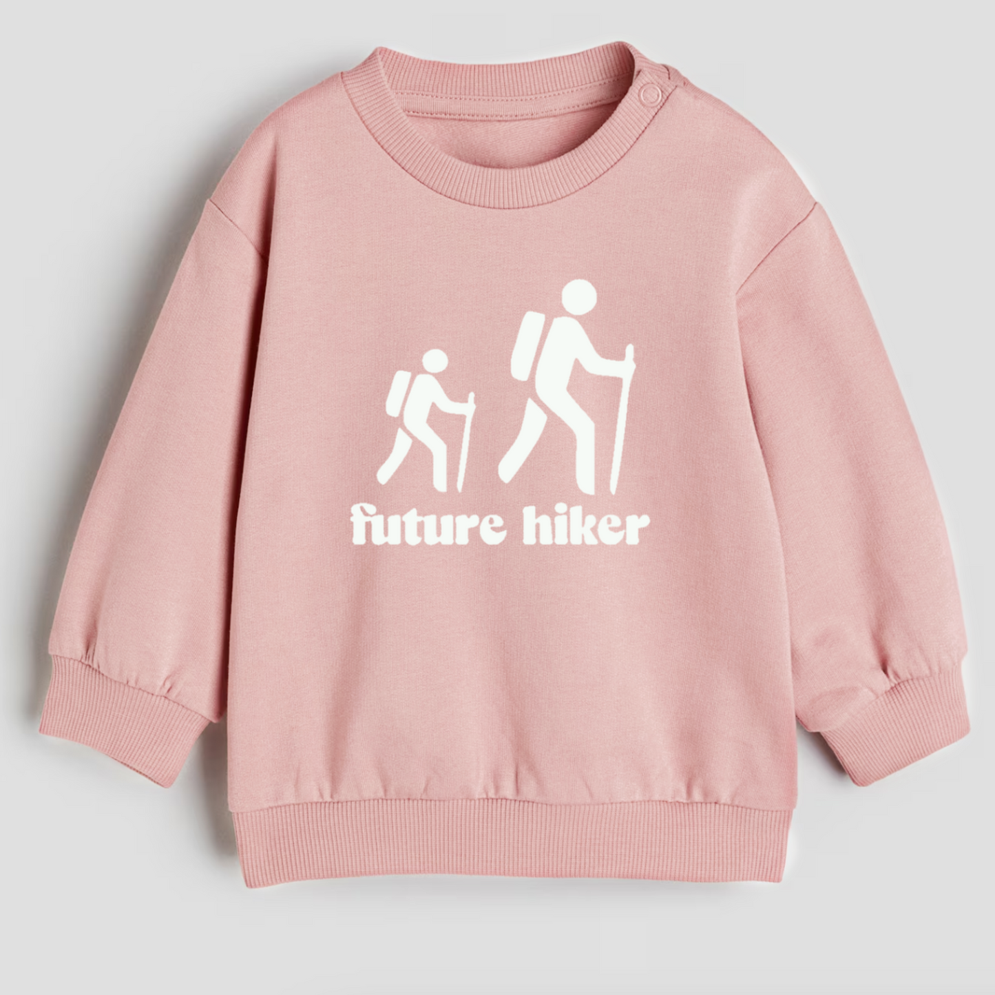 Pink sweatshirt with 'future hiker' design on a light gray background