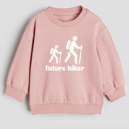 Pink sweatshirt with 'future hiker' design on a light gray background