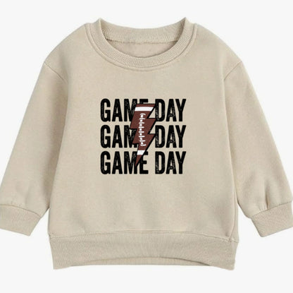 Beige sweatshirt with 'GAME DAY' text and lightning bolt design on a white background