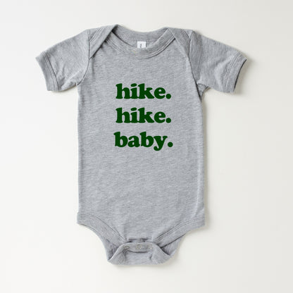 Gray baby onesie with green text 'hike. hike. baby.' on a white background