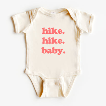 Beige baby onesie with 'hike. hike. baby.' text in red on a white background