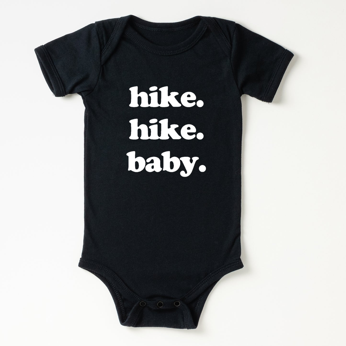Black baby onesie with 'hike. hike. baby.' text on a white background