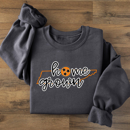 Dark gray sweatshirt with 'home grown' text on a wooden surface