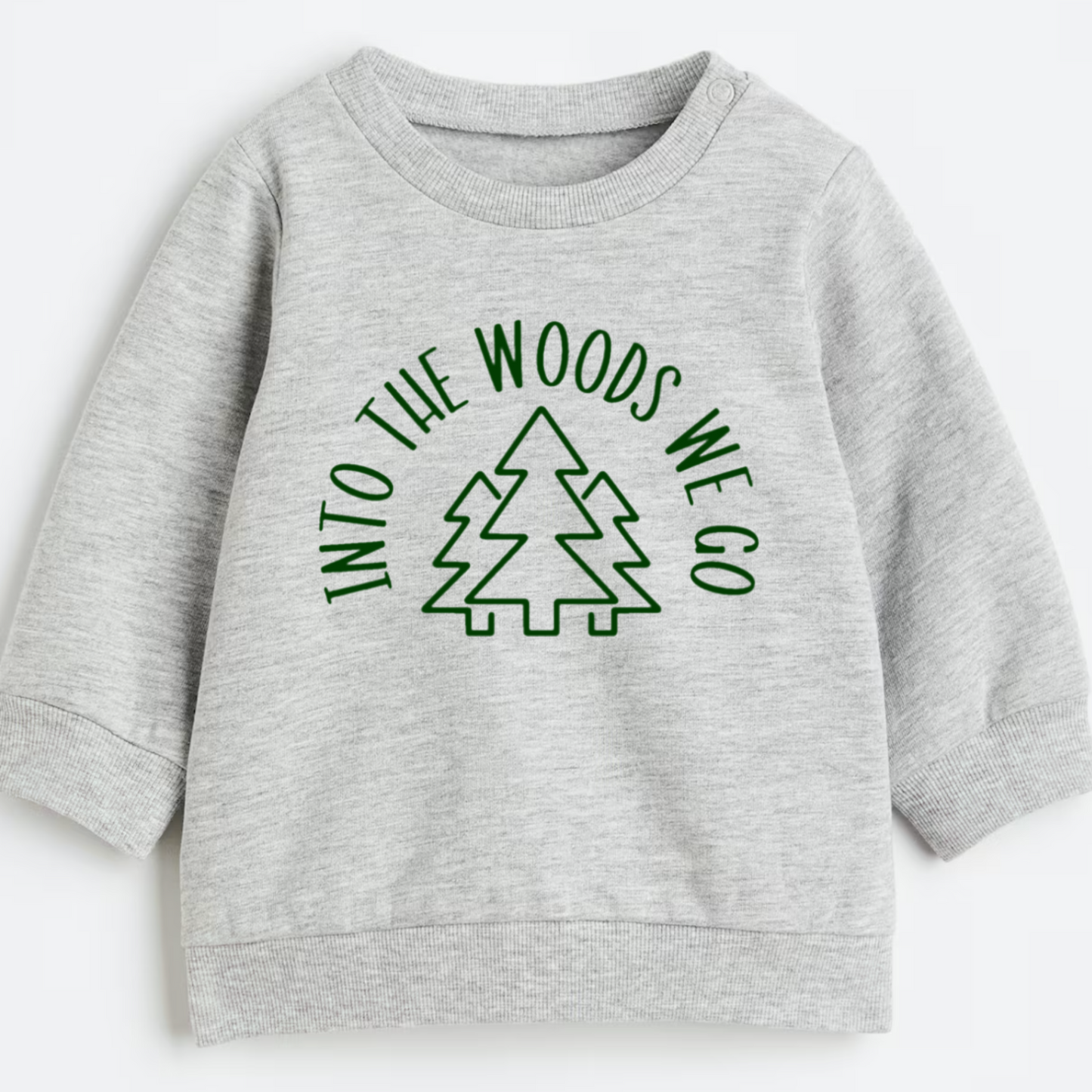 Gray sweatshirt with 'Into the Woods We Go' text and tree graphic on a white background