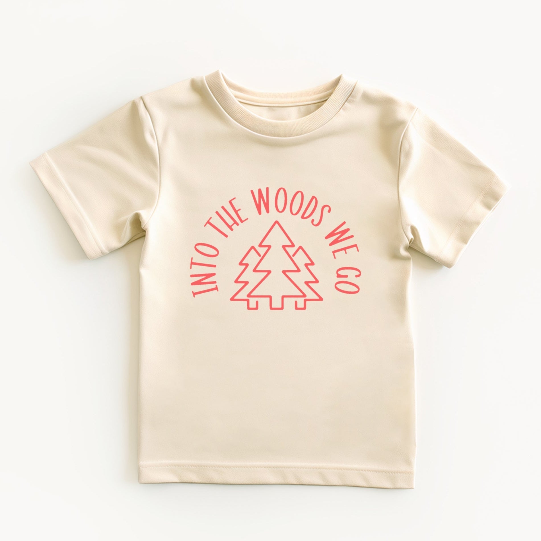 Beige t-shirt with pink into the woods text and tree graphic on a white background