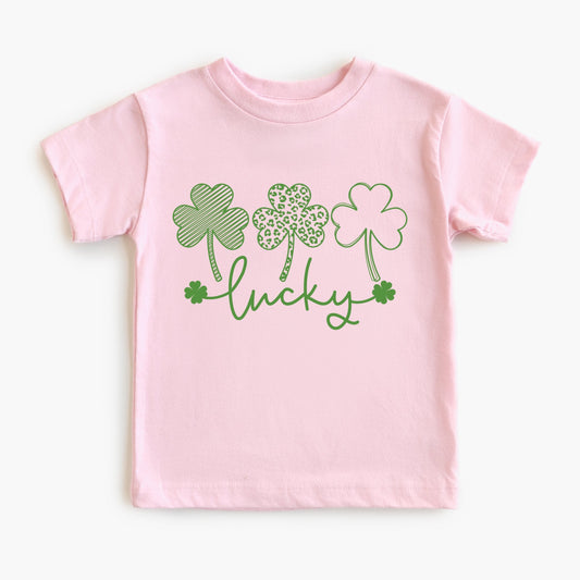Pink t-shirt with green shamrock design and 'lucky' text on a white background