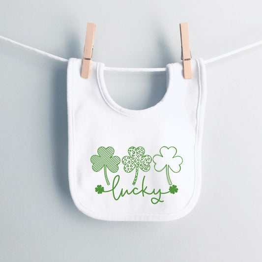 White bib with green shamrock design and 'lucky' text on a white background