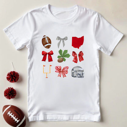 White t-shirt with sports-themed graphics on a beige background