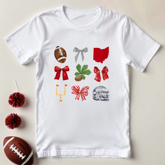 White t-shirt with sports-themed graphics on a beige background