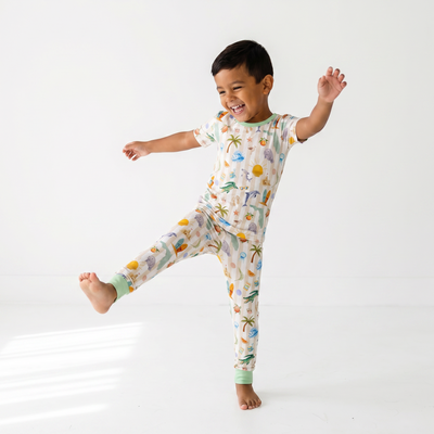 Child wearing a florida-patterned pajama set on a white background
