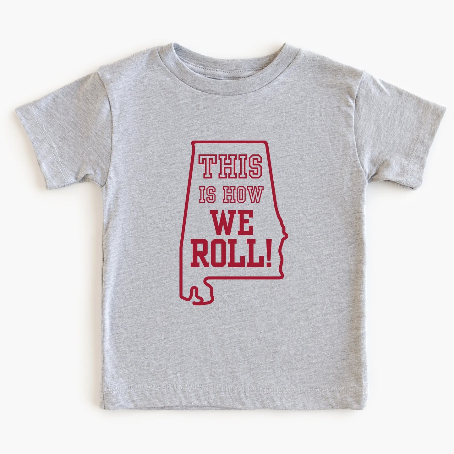 Gray t-shirt with red graphic and text 'THIS IS HOW WE ROLL!' on a white background