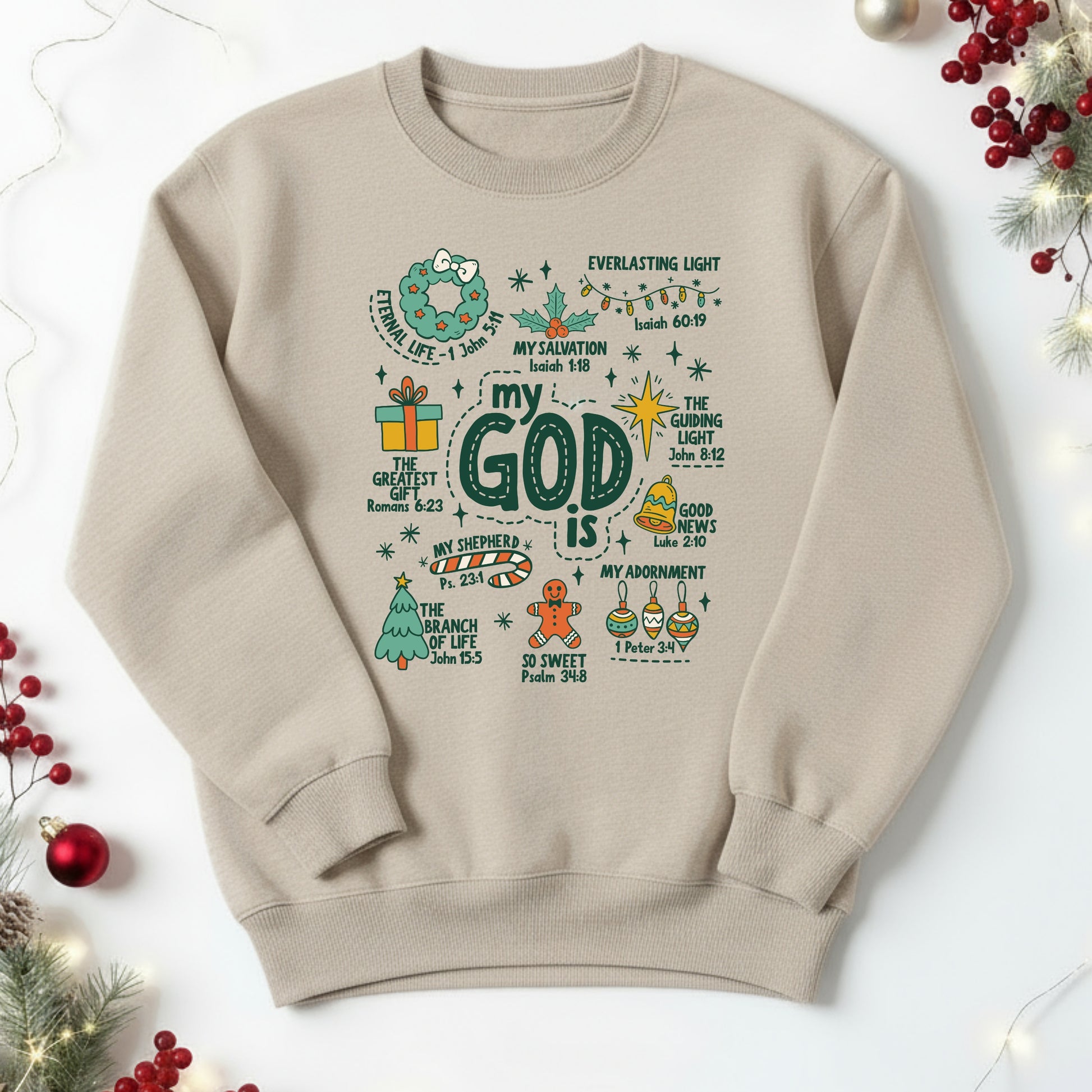 Beige sweatshirt with Christmas-themed text and graphics on a white background with holiday decorations.