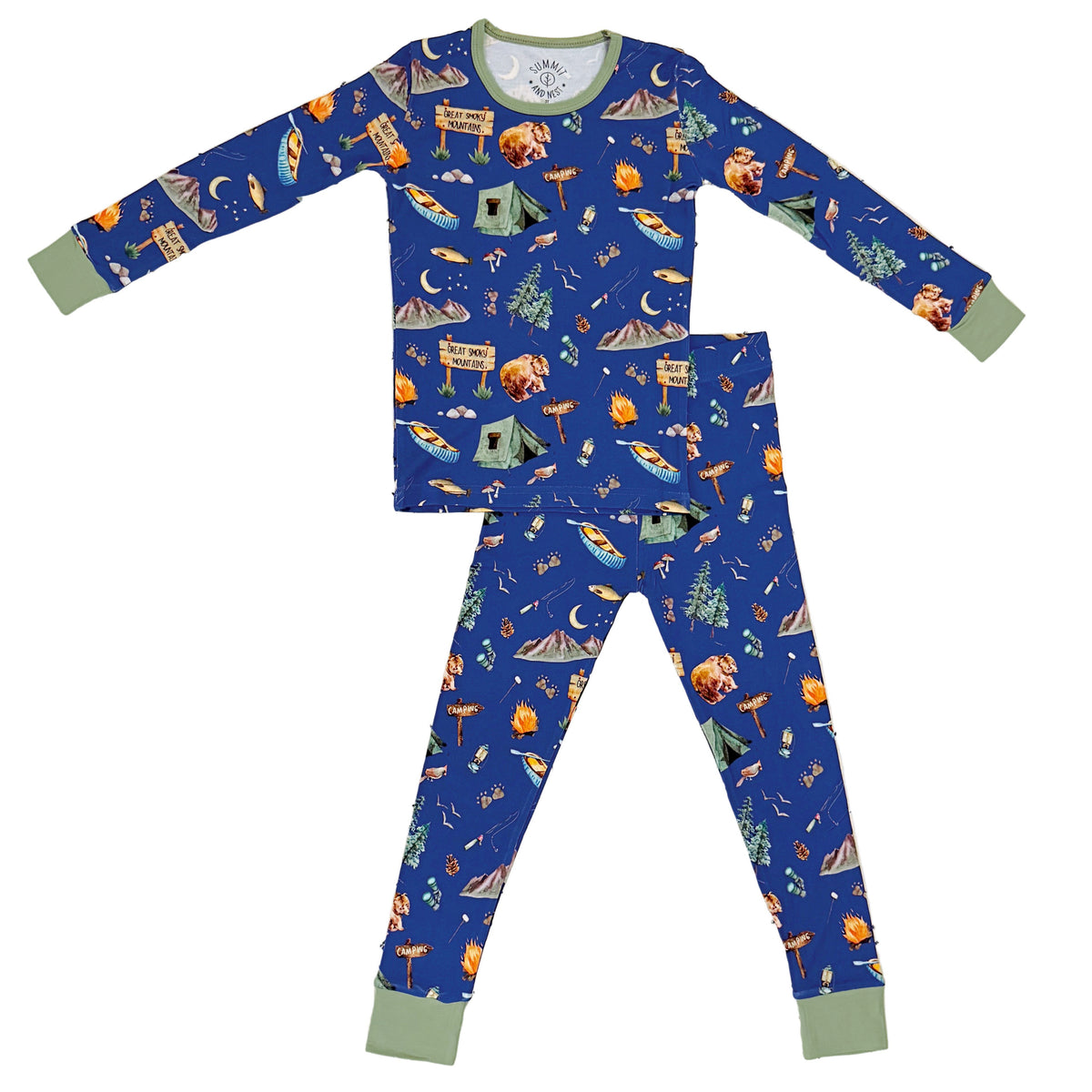 A two-piece long-sleeve pajama set for kids, featuring a blue background with a colorful camping-themed print of tents, campfires, trees, and mountains. The pajama top and pants have sage green cuffs and collar trim.