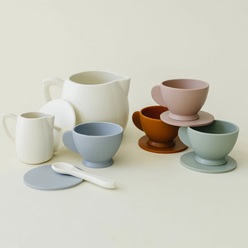 Set of silicone tea cups and a pitcher on a light background