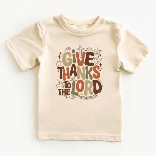 Beige t-shirt with 'Give Thanks to the Lord' text on a white background