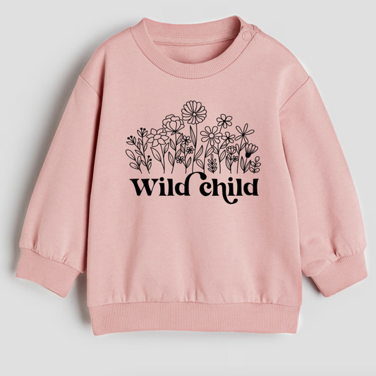 Pink sweatshirt with floral design and 'Wild Child' text on a light gray background
